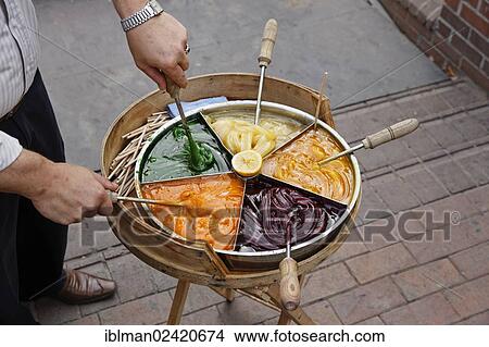 Picture - Traditional sweets on a wooden stick sold by a street vendor, Sultanahmet historic district, Istanbul, Turkey, Europe, PublicGround, Asia. Fotosearch