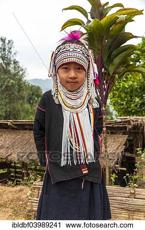 Stock Image - "Traditionally dressed girl from the Akha people, hill tribe, ethnic minority, Chiang Rai Province, Northern Thailand, Thailand, Asia". Fotosearch