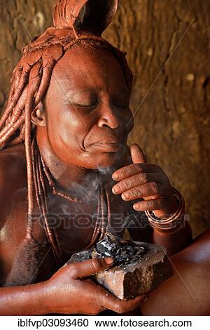 "Traditionally dressed Himba woman in her hut, applying perfume, Purros Traditional Village, Purros, Kaokoland, Kunene, Namibia, Africa" View Large Photo Image Stock Image - "Traditionally dressed Himba woman in her hut, applying perfume, Purros Traditional Village, Purros, Kaokoland, Kunene, Namibia, Africa". Fotosearch