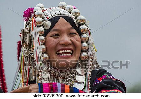 Stock Image - "Traditionally dressed woman from the Akha people, hill tribe, ethnic minority, portrait, Chiang Rai Province, Northern Thailand, Thailand, Asia". Fotosearch