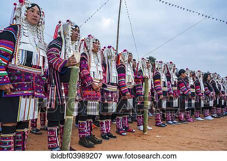 Stock Photo - "Traditionally dressed women from the Akha people, hill tribe, ethnic minority, dancing, New Year's celebrations, Chiang Rai Province, Northern Thailand, Thailand, Asia". Fotosearch
