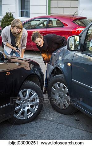 "Traffic accident, slight body damage to a car, crash while turning from an exit, accident participants discussing who is at fault, Germany, Europe" View Large Photo Image Stock Image - "Traffic accident, slight body damage to a car, crash while turning from an exit, accident participants discussing who is at fault, Germany, Europe". Fotosearch