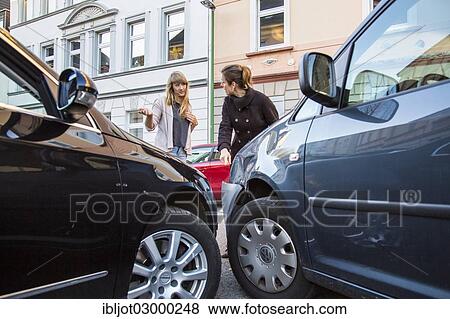 "Traffic accident, slight body damage to a car, crash while turning from an exit, accident participants discussing who is at fault, Germany, Europe" View Large Photo Image Stock Photo - "Traffic accident, slight body damage to a car, crash while turning from an exit, accident participants discussing who is at fault, Germany, Europe". Fotosearch