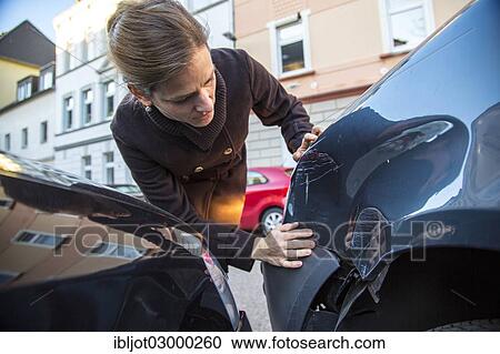 "Traffic accident, woman observing the slight body damage to a car, crash while turning from an exit, Germany, Europe" View Large Photo Image Stock Image - "Traffic accident, woman observing the slight body damage to a car, crash while turning from an exit, Germany, Europe". Fotosearch