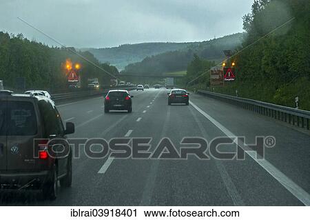 "Traffic during heavy rain with poor visibility, warning sign indicating a risk of traffic jams, A9 motorway near Thalmassing, Middle Franconia, Franconia, Bavaria, Germany, Europe" View Large Photo Image Stock Image - "Traffic during heavy rain with poor visibility, warning sign indicating a risk of traffic jams, A9 motorway near Thalmassing, Middle Franconia, Franconia, Bavaria, Germany, Europe". Fotosearch