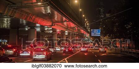 Stock Image - "Traffic under a raised road at night, Shanghai, China, Asia". Fotosearch