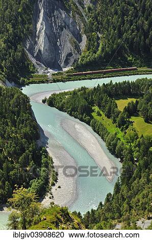"Train of the Rhaetian Railway on the riverbanks of the Vorderrhein, Ruinaulta valley, at Illanz, Canton of Graubunden, Switzerland, Europe" View Large Photo Image Stock Image - "Train of the Rhaetian Railway on the riverbanks of the Vorderrhein, Ruinaulta valley, at Illanz, Canton of Graubunden, Switzerland, Europe". Fotosearch