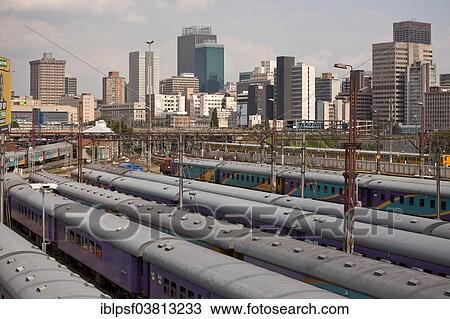 "Train tracks and trains at the central railway station of Park Station and the skyline of Johannesburg, Gauteng, South Africa, Africa" View Large Photo Image Stock Image - "Train tracks and trains at the central railway station of Park Station and the skyline of Johannesburg, Gauteng, South Africa, Africa". Fotosearch