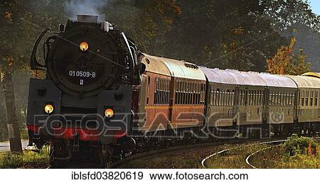 "Train with old carriages of the Deutsche Reichsbahn railway being pulled by a steam locomotive, Lubbenau, Brandenburg, Germany, Europe" View Large Photo Image Stock Photo - "Train with old carriages of the Deutsche Reichsbahn railway being pulled by a steam locomotive, Lubbenau, Brandenburg, Germany, Europe". Fotosearch