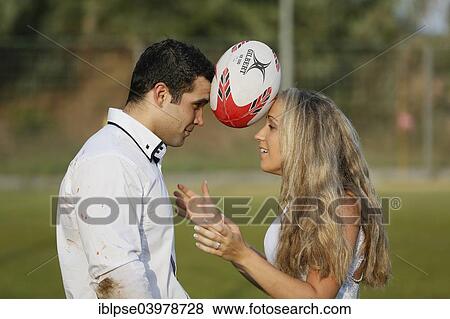 "Trash the dress, bride and groom playing rugby" View Large Photo Image Stock Photo - "Trash the dress, bride and groom playing rugby". Fotosearch