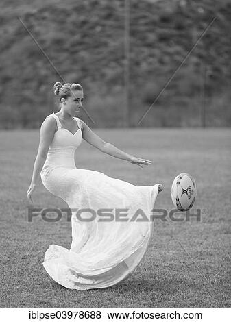 "Trash the dress, Rugby, bride playing the ball" View Large Photo Image Stock Photo - "Trash the dress, Rugby, bride playing the ball". Fotosearch