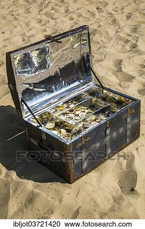 Treasure chest with gold and silver coins on the sand View Large Photo Image Stock Image - Treasure chest with gold and silver coins on the sand. Fotosearch