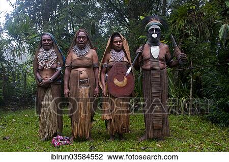 Stock Image - "Tribal chief and three women wearing traditional dresses, Highlands Region, Papua New Guinea, Oceania". Fotosearch