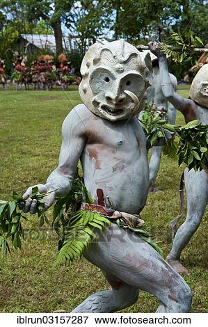 Stock Photo - "Tribal members in masks and full body paint are celebrating at the traditional Sing Sing gathering in the highlands, Paya, Papua New Guinea, Oceania". Fotosearch