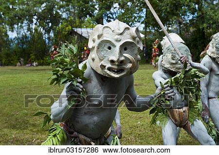 Stock Photograph - "Tribal members in masks and full body paint are celebrating at the traditional Sing Sing gathering in the highlands, Paya, Papua New Guinea, Oceania". Fotosearch