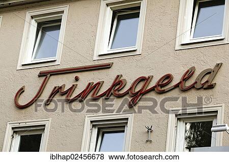Stock Photo - "Trinkgeld, German for tip, sign on a house in Dachau, Upper Bavaria, Germany, Europe". Fotosearch