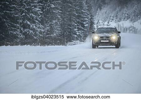 Stock Photography - "Truck driving on snowy road, winter driving, Norway, Europe". Fotosearch