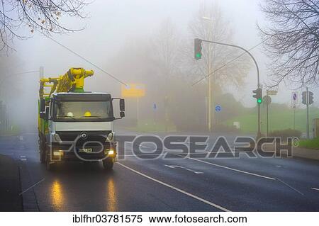 Stock Photography - "Truck in motion on a foggy morning, Grevenbroich, North Rhine-Westphalia, Germany, Europe". Fotosearch