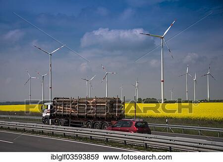 "Truck loaded with timber, and cars on a motorway in front of a wind farm and a rape field, Egeln, Saxony-Anhalt, Germany, Europe" View Large Photo Image Stock Photo - "Truck loaded with timber, and cars on a motorway in front of a wind farm and a rape field, Egeln, Saxony-Anhalt, Germany, Europe". Fotosearch