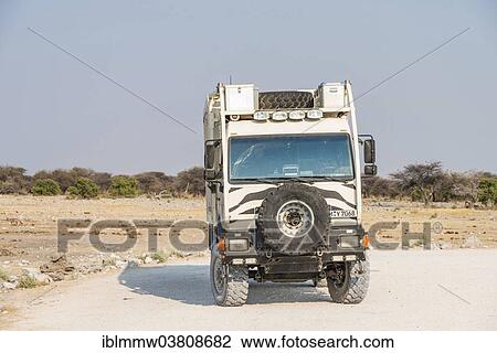 Stock Image - "Truck with zebra stripes at the Chudop waterhole, Etosha National Park, Namibia, Africa". Fotosearch