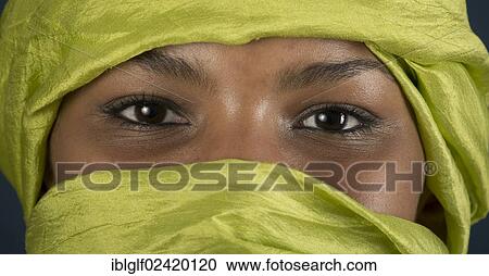 Stock Image - Tuareg girl, Targia, veiled with a chech with only her eyes visible, Algeria, North Africa, Africa. Fotosearch