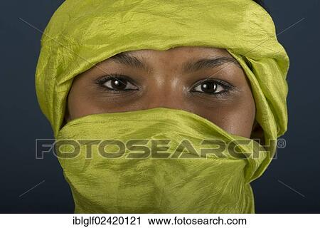 Stock Image - Tuareg girl, Targia, veiled with a chech with only her eyes visible, Algeria, North Africa, Africa. Fotosearch