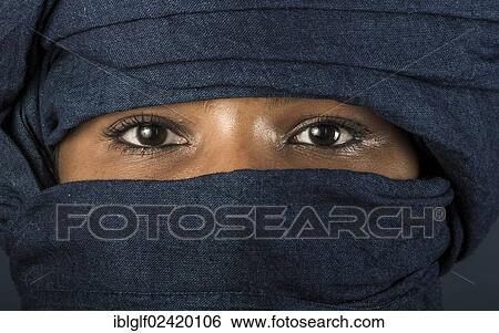 Stock Photograph - Tuareg girl, Targia, veiled with a chech with only her eyes visible, Algeria, North Africa, Africa. Fotosearch