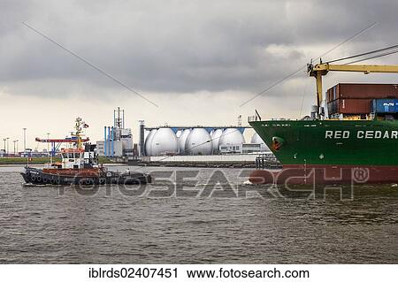 "Tug boat towing a container ship on the Elbe, Hamburg, Germany, Europe" View Large Photo Image Stock Image - "Tug boat towing a container ship on the Elbe, Hamburg, Germany, Europe". Fotosearch