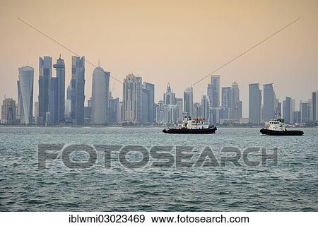 "Tugboats in front of the skyline of Doha at dusk, Doha Corniche, Doha, Doha, Qatar, Asia" View Large Photo Image Stock Photo - "Tugboats in front of the skyline of Doha at dusk, Doha Corniche, Doha, Doha, Qatar, Asia". Fotosearch