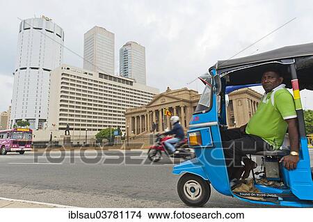 "Tuk tuk driver with the building of the Bank of Ceylon at the back, the Old Parliament, right, Colombo, Sri Lanka, Asia" View Large Photo Image Picture - "Tuk tuk driver with the building of the Bank of Ceylon at the back, the Old Parliament, right, Colombo, Sri Lanka, Asia". Fotosearch