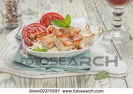 Turkey skewers on rice with tomato sauce and grilled tomatoes View Large Photo Image Stock Photo - Turkey skewers on rice with tomato sauce and grilled tomatoes. Fotosearch