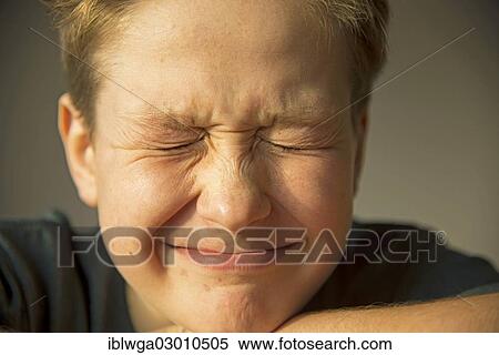 "Twelve year old boy squinting his eyes, first signs of acne on the face, puberty, Germany, Europe" View Large Photo Image Stock Photography - "Twelve year old boy squinting his eyes, first signs of acne on the face, puberty, Germany, Europe". Fotosearch