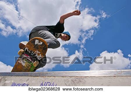 "Twelve-year-old skater performing a boardslide, Blaubeuren skate park, Baden-Wuerttemberg, Germany, Europe, PublicGround, Europe" View Large Photo Image Stock Photo - "Twelve-year-old skater performing a boardslide, Blaubeuren skate park, Baden-Wuerttemberg, Germany, Europe, PublicGround, Europe". Fotosearch