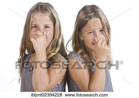 "Twin girls, 9, holding their noses closed" View Large Photo Image Stock Photo - "Twin girls, 9, holding their noses closed". Fotosearch