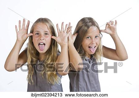 "Twin girls, 9, making grimaces" View Large Photo Image Stock Image - "Twin girls, 9, making grimaces". Fotosearch