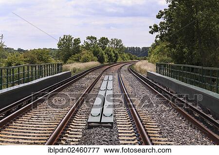 Stock Photo - "Twin track railway line disappearing around a bend, United Kingdom, Europe". Fotosearch