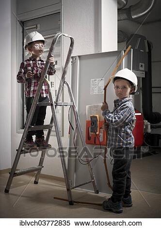 Twins with hard hats at play as construction workers View Large Photo Image Stock Photography - Twins with hard hats at play as construction workers. Fotosearch