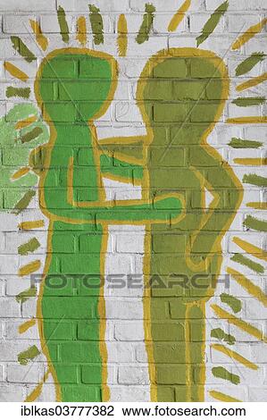 Stock Image - "Two abstract figures embrace, mural in a school playground, Germany, Europe". Fotosearch