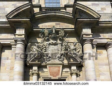 "Two angels holding the coat of arms of Prince-Abbot Adalbert von Schleifras above the main entrance of St. Salvator Cathedral of Fulda, Fulda Cathedral, Fulda, Fulda, Hesse, Germany, Europe" View Large Photo Image Stock Photography - "Two angels holding the coat of arms of Prince-Abbot Adalbert von Schleifras above the main entrance of St. Salvator Cathedral of Fulda, Fulda Cathedral, Fulda, Fulda, Hesse, Germany, Europe". Fotosearch