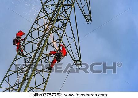 Stock Image - "Two assembly fitters working on a pylon, Grevenbroich, North Rhine-Westphalia, Germany, Europe". Fotosearch