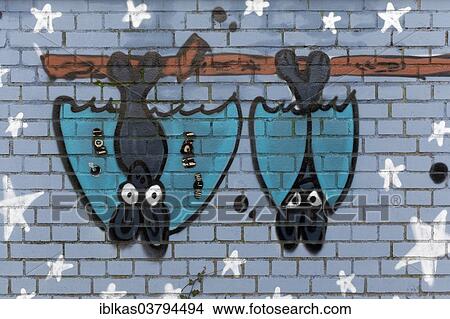 "Two bat figures hanging upside down on a pole, mural, North Rhine-Westphalia, Germany, Europe" View Large Photo Image Picture - "Two bat figures hanging upside down on a pole, mural, North Rhine-Westphalia, Germany, Europe". Fotosearch