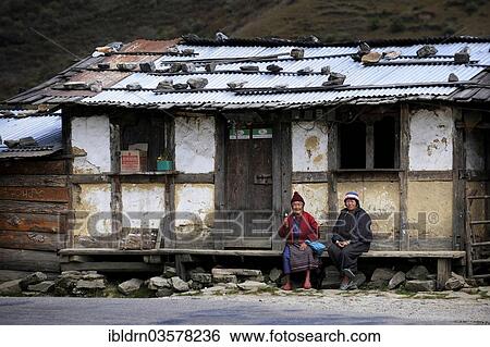 "Two Bhutanese women sitting in front of a small shop on the roadside, Pela La Pass, Wangdue Phodrang District, Bhutan, Asia" View Large Photo Image Stock Photograph - "Two Bhutanese women sitting in front of a small shop on the roadside, Pela La Pass, Wangdue Phodrang District, Bhutan, Asia". Fotosearch