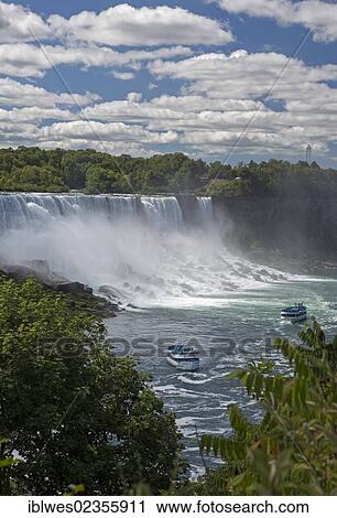Stock Image - "Two boats in the Maid of the Mist fleet carry tourists to the edge of the falls, Niagara Falls, Ontario, Canada, North America". Fotosearch