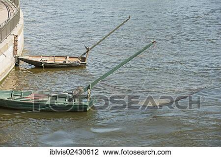 "Two boats with old-fashioned nets in the center of Stockholm, Sweden, Europe" View Large Photo Image Stock Image - "Two boats with old-fashioned nets in the center of Stockholm, Sweden, Europe". Fotosearch