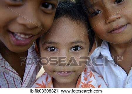 "Two boys and a girl, standing close together, portrait, Lompong Village, Bathi District, Takeo Province, Cambodia, Asia" View Large Photo Image Stock Photo - "Two boys and a girl, standing close together, portrait, Lompong Village, Bathi District, Takeo Province, Cambodia, Asia". Fotosearch