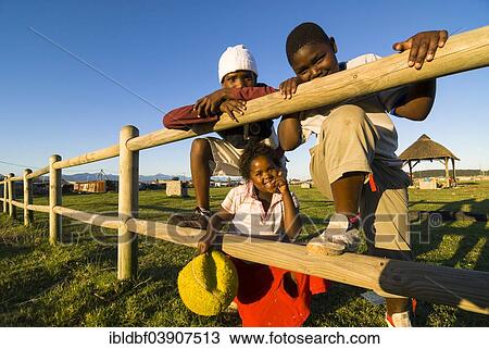 "Two boys and a girl with a ball, Township, Plettenberg Bay, Garden Route, Eden District, Western Cape, South Africa, Africa" View Large Photo Image Stock Image - "Two boys and a girl with a ball, Township, Plettenberg Bay, Garden Route, Eden District, Western Cape, South Africa, Africa". Fotosearch