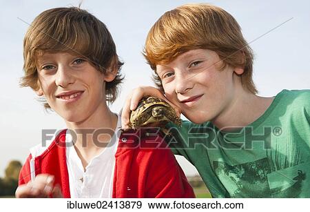 Two boys holding a turtle View Large Photo Image Stock Photo - Two boys holding a turtle. Fotosearch
