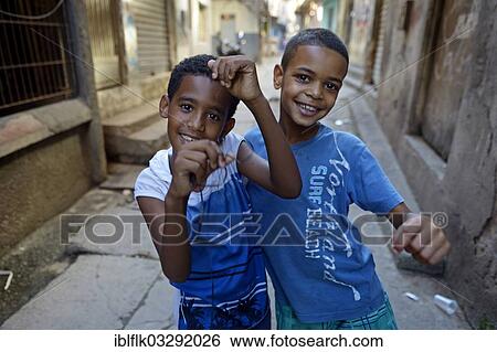 "Two boys in a slum or favela, Jacarezinho favela, Rio de Janeiro, Rio de Janeiro State, Brazil, South America" View Large Photo Image Stock Photograph - "Two boys in a slum or favela, Jacarezinho favela, Rio de Janeiro, Rio de Janeiro State, Brazil, South America". Fotosearch