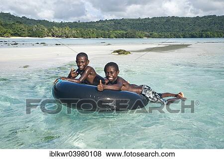 "Two boys playing in the clear water, Espiritu Santo, Vanuatu, Oceania" View Large Photo Image Stock Photo - "Two boys playing in the clear water, Espiritu Santo, Vanuatu, Oceania". Fotosearch