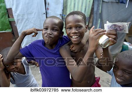 "Two boys posing with money, alcohol and gesture of a gun, gestures for the criminal idols of the children, Camp Icare for earthquake refugees, Fort National, Port-au-Prince, Haiti, North America" View Large Photo Image Stock Photography - "Two boys posing with money, alcohol and gesture of a gun, gestures for the criminal idols of the children, Camp Icare for earthquake refugees, Fort National, Port-au-Prince, Haiti, North America". Fotosearch